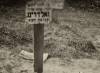 Symbolic grave in Jewish ghetto cemetery. Sign reads:
"Here lies the girl Hinda ? daughter of Shelomoh Tsvi May his light shine Goldring. Died 16th Tevet 5701."

Translated by Heidi M. Szpek, Ph.D. (szpekh@cwu.edu), Assistant Professor of Religious Studies, Department of Philosophy and Religious Studies, Central Washington University, Ellensburg, WA 98926